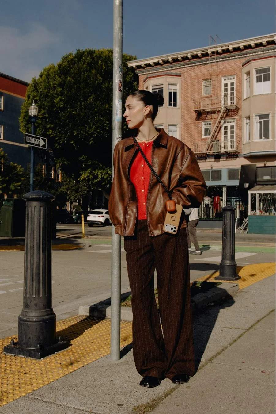 女性がスマホを肩掛けしている